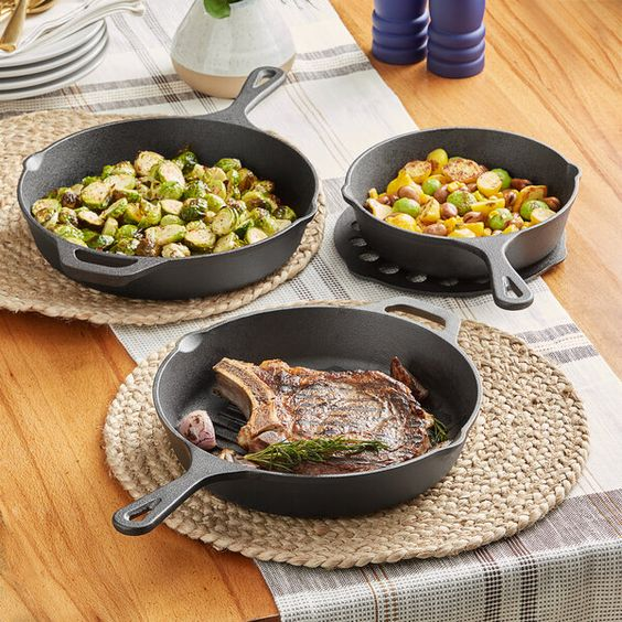 seasoned cast iron cookware on the wooden table