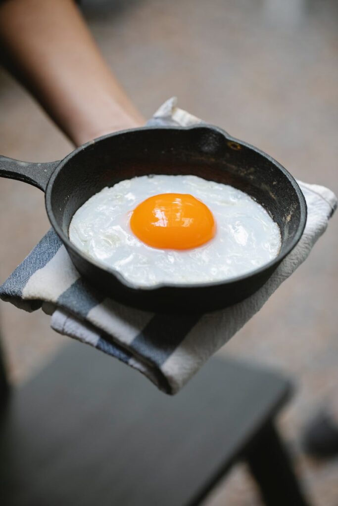 Seasoned cast iron skillet frying eggs in restaurant